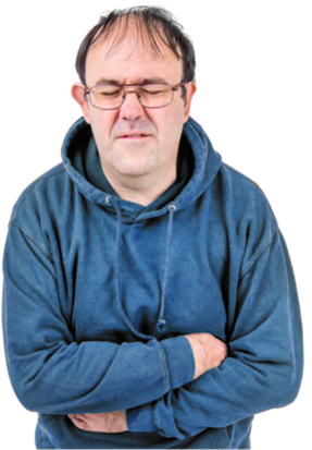 A man with his arms wrapped around his stomach and a look of pain on his face