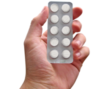 a hand holding a packet of tablets