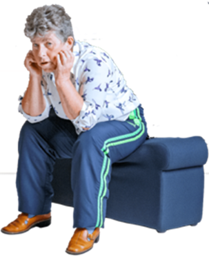 A woman sitting ona blue bench leaning forward with her elbows on her knees looking fed up