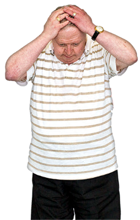 A man looking down with both hands on his head
