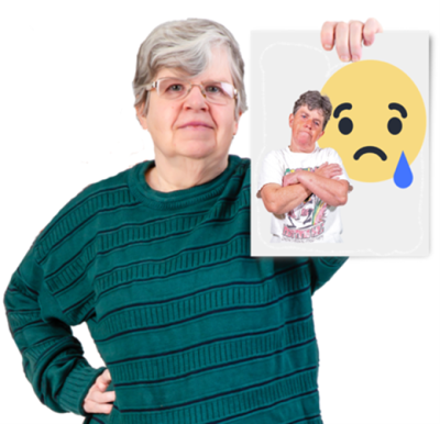 A woman holding a picture of a sad face