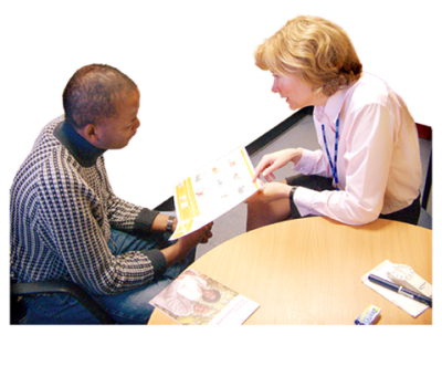 A lady doctor showing a man an information leaflet.