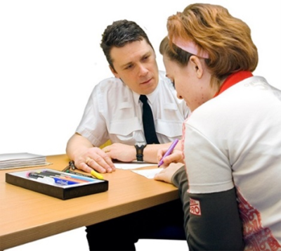 A young woman talking to a prison officer