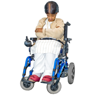 A woman sitting alone with her head bent and arms crossed