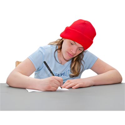 A woman sitting at a desk writing A woman sitting at a desk writing