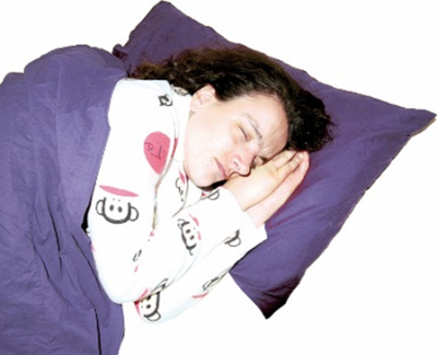A young woman lying asleep in bed