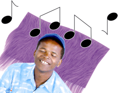 A smiling man with his eyes closed listening to music