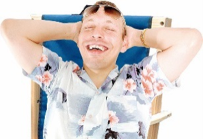 A happy man with sunglasses on lying on a deckchair